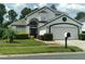 Two-story house with a white exterior, black accents, and a two-car garage at 2863 Picadilly Cir, Kissimmee, FL 34747