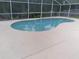 Inviting kidney-shaped pool with screened enclosure at 2863 Picadilly Cir, Kissimmee, FL 34747