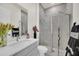 Clean bathroom with a walk-in shower, gray tile, and modern vanity at 7401 Levee Ln, Celebration, FL 34747