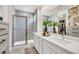 Elegant bathroom with dual sinks, a walk-in shower, and modern finishes at 7401 Levee Ln, Celebration, FL 34747