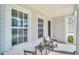 Front porch with rocking chairs and side yard view at 7401 Levee Ln, Celebration, FL 34747