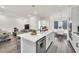 Open kitchen with island, white cabinets, and gray floors at 7401 Levee Ln, Celebration, FL 34747