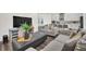 Open living room with gray sofas, a large TV, and a view of the kitchen at 7401 Levee Ln, Celebration, FL 34747