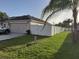 Backyard view showcasing a white fence and grassy area at 924 Derbyshire Dr, Kissimmee, FL 34758