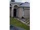 House exterior featuring a front door and walkway at 924 Derbyshire Dr, Kissimmee, FL 34758