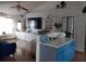 Open concept kitchen and living area with blue cabinets and a large TV at 924 Derbyshire Dr, Kissimmee, FL 34758
