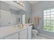 Clean bathroom with a white vanity, a large mirror, and ample lighting at 705 Ashton Dr, Davenport, FL 33837