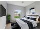 Modern bedroom with a comfortable bed, a large window, and stylish decor at 705 Ashton Dr, Davenport, FL 33837