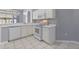Bright kitchen featuring white cabinets, modern appliances, and neutral tile flooring at 705 Ashton Dr, Davenport, FL 33837