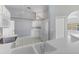 Bright kitchen featuring white cabinets, a stainless steel refrigerator, and modern appliances at 705 Ashton Dr, Davenport, FL 33837