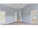 Bright main bedroom with a ceiling fan and doors to bathroom and other rooms at 705 Ashton Dr, Davenport, FL 33837