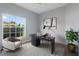 Bright home office with a large window, contemporary desk, and comfortable seating at 705 Ashton Dr, Davenport, FL 33837