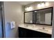 Modern bathroom featuring double sinks, a large mirror, and ample counter space at 14501 Grove Resort Ave # 1637, Winter Garden, FL 34787