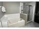 Modern bathroom featuring a soaking tub and a separate glass-enclosed shower at 14501 Grove Resort Ave # 1637, Winter Garden, FL 34787