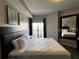 Comfortable bedroom featuring a plush bed, elegant decor, and natural light from the window at 14501 Grove Resort Ave # 1637, Winter Garden, FL 34787