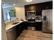 Modern kitchen with stainless steel appliances and stylish dark wood cabinets at 14501 Grove Resort Ave # 1637, Winter Garden, FL 34787