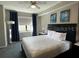 Comfortable main bedroom featuring a plush bed, elegant decor, and natural light from the window at 14501 Grove Resort Ave # 1637, Winter Garden, FL 34787
