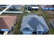 Aerial view of a single-Gathering home with a gray roof and landscaped yard at 959 Nancy Ct, Kissimmee, FL 34759