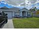 Charming single-story home featuring a well-maintained lawn and inviting entryway at 959 Nancy Ct, Kissimmee, FL 34759