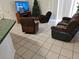 Living room featuring a comfortable sofa, recliners, and a TV with a Christmas tree at 959 Nancy Ct, Kissimmee, FL 34759