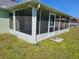 Exterior shot of enclosed patio with screen panels and concrete foundation at 959 Nancy Ct, Kissimmee, FL 34759