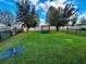 Large backyard with grassy area, trampoline, and trees at 2755 Monticello Way, Kissimmee, FL 34741