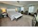 Main bedroom with plush bed and sitting area at 2755 Monticello Way, Kissimmee, FL 34741