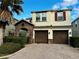 Two-story house with two-car garage and landscaping at 2755 Monticello Way, Kissimmee, FL 34741