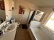 Bathroom featuring a combined bathtub/shower and a single sink vanity at 2585 Needlepoint St, Kissimmee, FL 34741