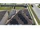 Aerial view of a home with newly installed solar panels on a brown shingle roof at 2585 Needlepoint St, Kissimmee, FL 34741