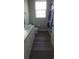 Bathroom featuring tile flooring, white vanity, cabinets, a toilet and a tub with shower and a blue shower curtain at 2307 Butterfly Palm Way # 201, Kissimmee, FL 34747