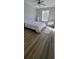 Bright bedroom with a ceiling fan, large window and hardwood floors at 2307 Butterfly Palm Way # 201, Kissimmee, FL 34747