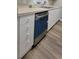 Kitchen with stainless steel dishwasher and white cabinets, providing both convenience and storage space at 2307 Butterfly Palm Way # 201, Kissimmee, FL 34747