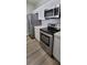 Modern kitchen with stainless steel appliances, white cabinetry, and sleek countertops, offering style and functionality at 2307 Butterfly Palm Way # 201, Kissimmee, FL 34747