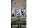 Open-concept living space visible from the kitchen, featuring modern furnishings, natural light, and inviting decor at 2307 Butterfly Palm Way # 201, Kissimmee, FL 34747