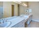 Bright bathroom featuring double sinks, gold hardware, and ample counter space at 441 Mayfair Dr, Kissimmee, FL 34759