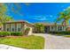 Charming single-story home featuring a brick driveway, well-manicured landscaping, and a welcoming front porch at 441 Mayfair Dr, Kissimmee, FL 34759
