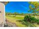 Picturesque view of the golf course from the property, featuring lush greenery and mature trees on a sunny day at 441 Mayfair Dr, Kissimmee, FL 34759