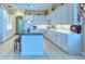 Bright kitchen featuring white cabinets, an island with seating, and modern appliances at 441 Mayfair Dr, Kissimmee, FL 34759
