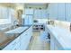 Spacious kitchen with white cabinetry, an island sink, and ample counter space for meal preparation at 441 Mayfair Dr, Kissimmee, FL 34759