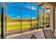 Screened lanai boasts scenic views of a lush golf course and blue skies at 441 Mayfair Dr, Kissimmee, FL 34759