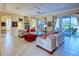 Bright living room featuring tile flooring, comfortable seating, and sliding glass doors leading to the outdoor patio at 441 Mayfair Dr, Kissimmee, FL 34759