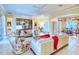 Inviting living room with tile floors, floral accents, and ample seating for entertaining guests at 441 Mayfair Dr, Kissimmee, FL 34759