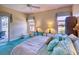 Comfortable main bedroom featuring plush bedding, ample natural light, and access to an outdoor space at 441 Mayfair Dr, Kissimmee, FL 34759
