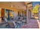 Comfortable screened-in patio with chairs, a table, and beautiful surroundings at 441 Mayfair Dr, Kissimmee, FL 34759