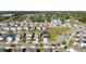 High aerial view of a community with a playground and some houses with solar panels at 1134 Forest Gate Cir, Haines City, FL 33844