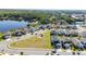 Aerial view of a home and community showing a park and lake nearby at 1134 Forest Gate Cir, Haines City, FL 33844