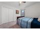 Cozy bedroom featuring a window with decorative curtains, plush carpet, and a closet for storage at 1134 Forest Gate Cir, Haines City, FL 33844