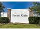 A sign for Forest Gate featuring brick and stone pillars at 1134 Forest Gate Cir, Haines City, FL 33844