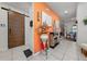 Inviting entryway featuring a modern barn door, vibrant wall color, and decorative fireplace at 1134 Forest Gate Cir, Haines City, FL 33844